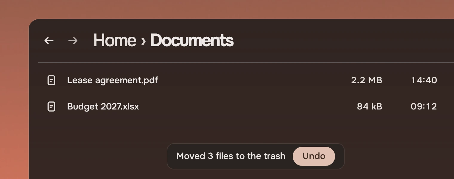 A Files window headed Home, Documents with two files. At its foot a line reads Moved 3 files to the trash, with an accent button, Undo.