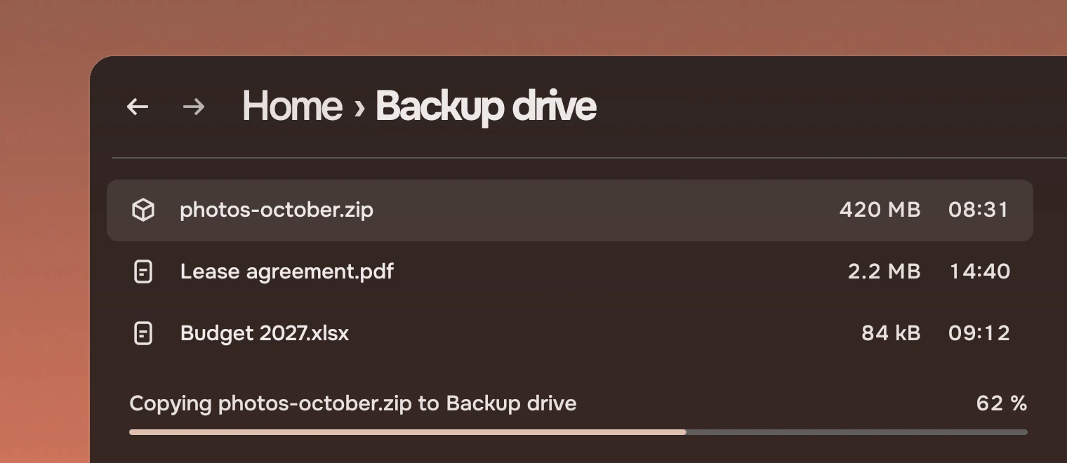 Part of a file manager window with three files listed and, under them, the line "Copying photos-october.zip to Backup drive, 62 %" with a thin bar below it filled to a little more than half.